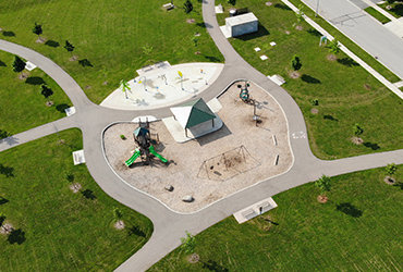 Aerial view of a park with gray paths and lots of green space.